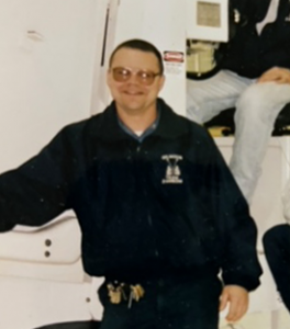 Michael posing in front of an ambulance during his time as a first responder